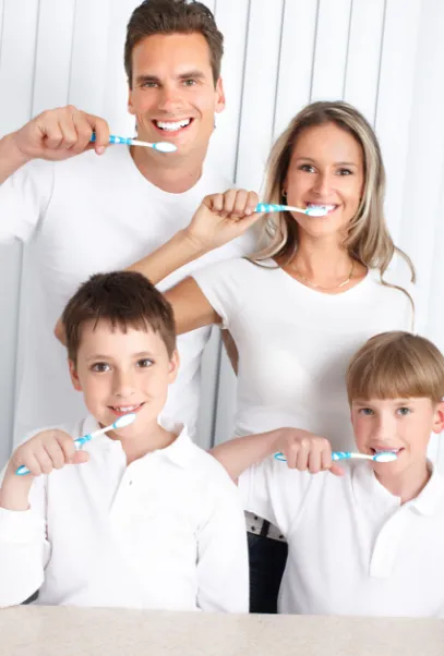 Family of four brushing their teeth