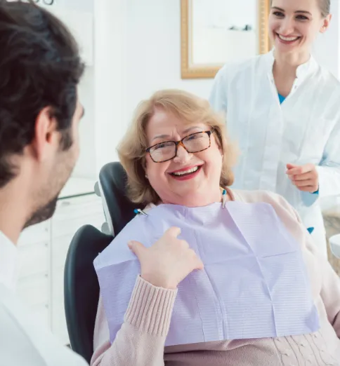 Female patient sitting in dental chair and smiling