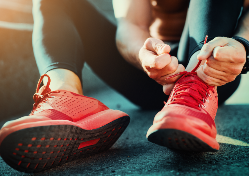 Close up of runner tying shoes